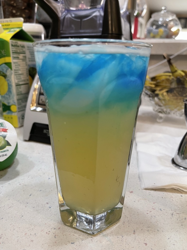 Blue and yellow layered cocktail